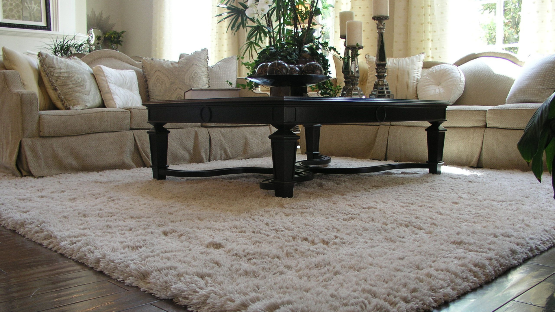 A living room with a rug and a coffee table