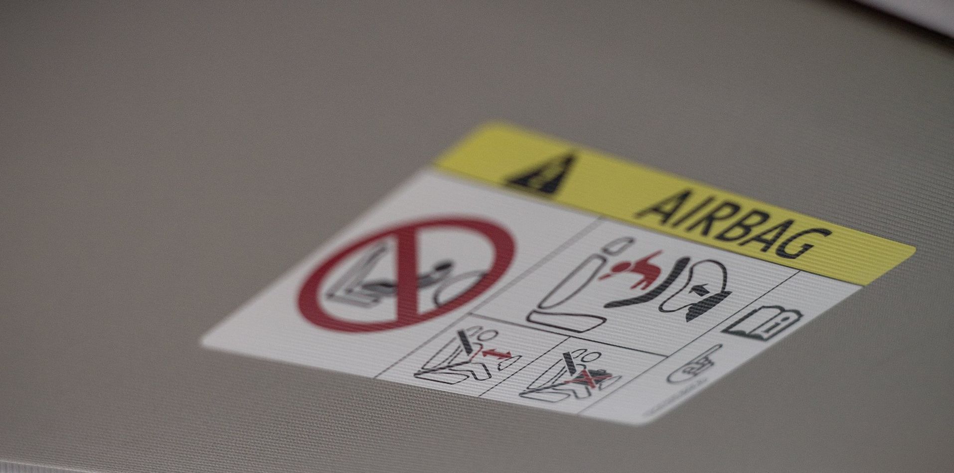 a close up of an airbag warning sticker on a car