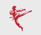 A man in a karate uniform is kicking in the air.