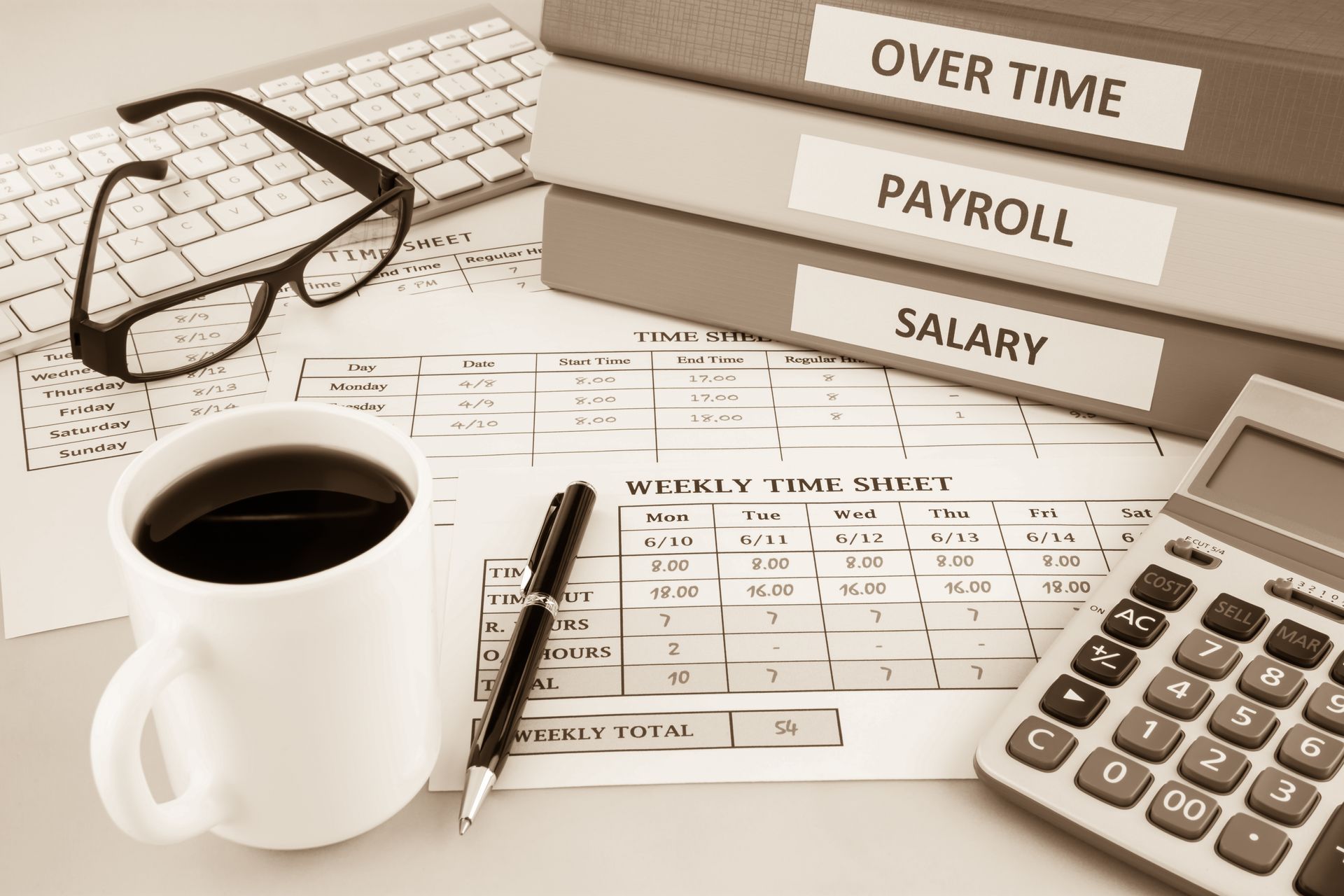 Payroll and overtime documents with calculator, coffee, pen, glasses, and folders on a desk
