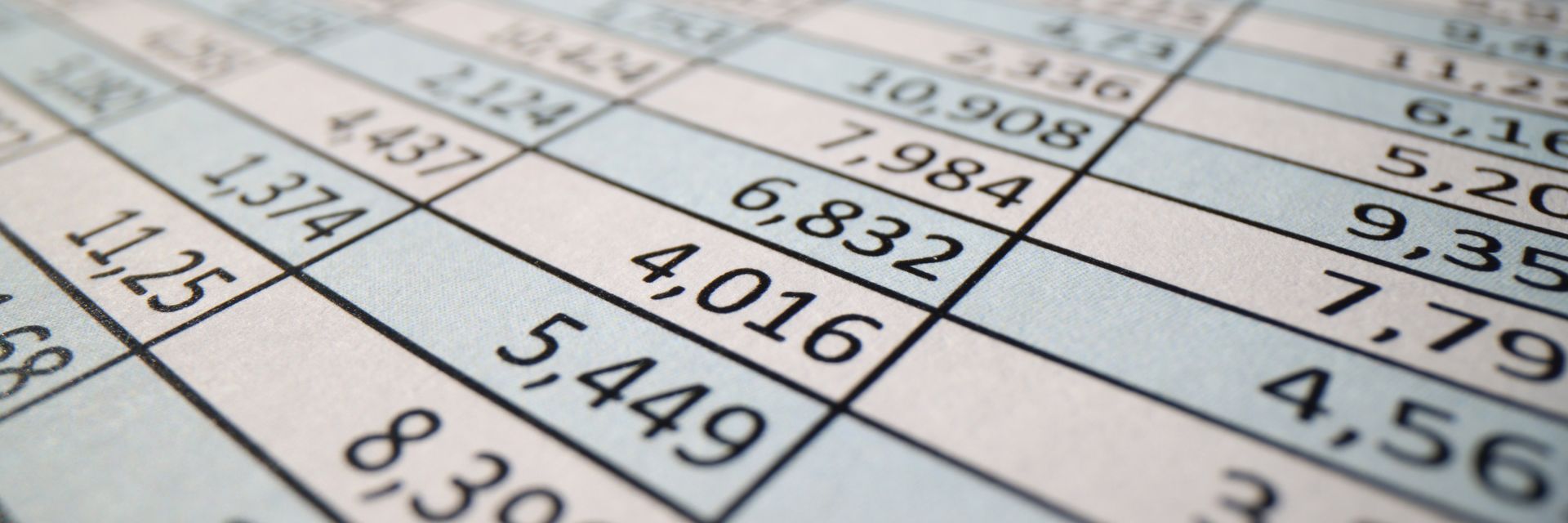Close-up of a printed number chart with diagonal grid lines and black and blue figures on a white background