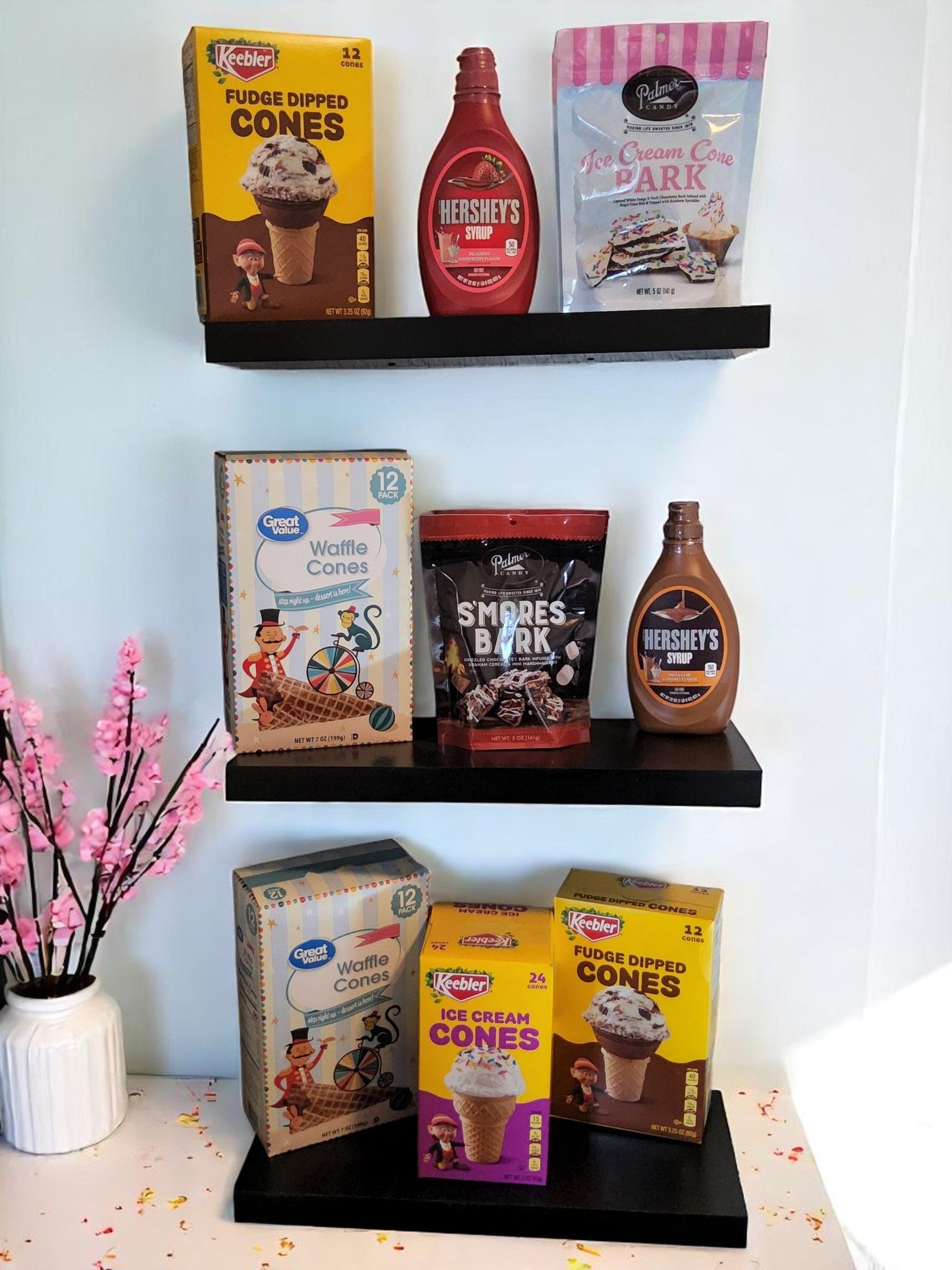 A shelf filled with a variety of food items including ice cream cones