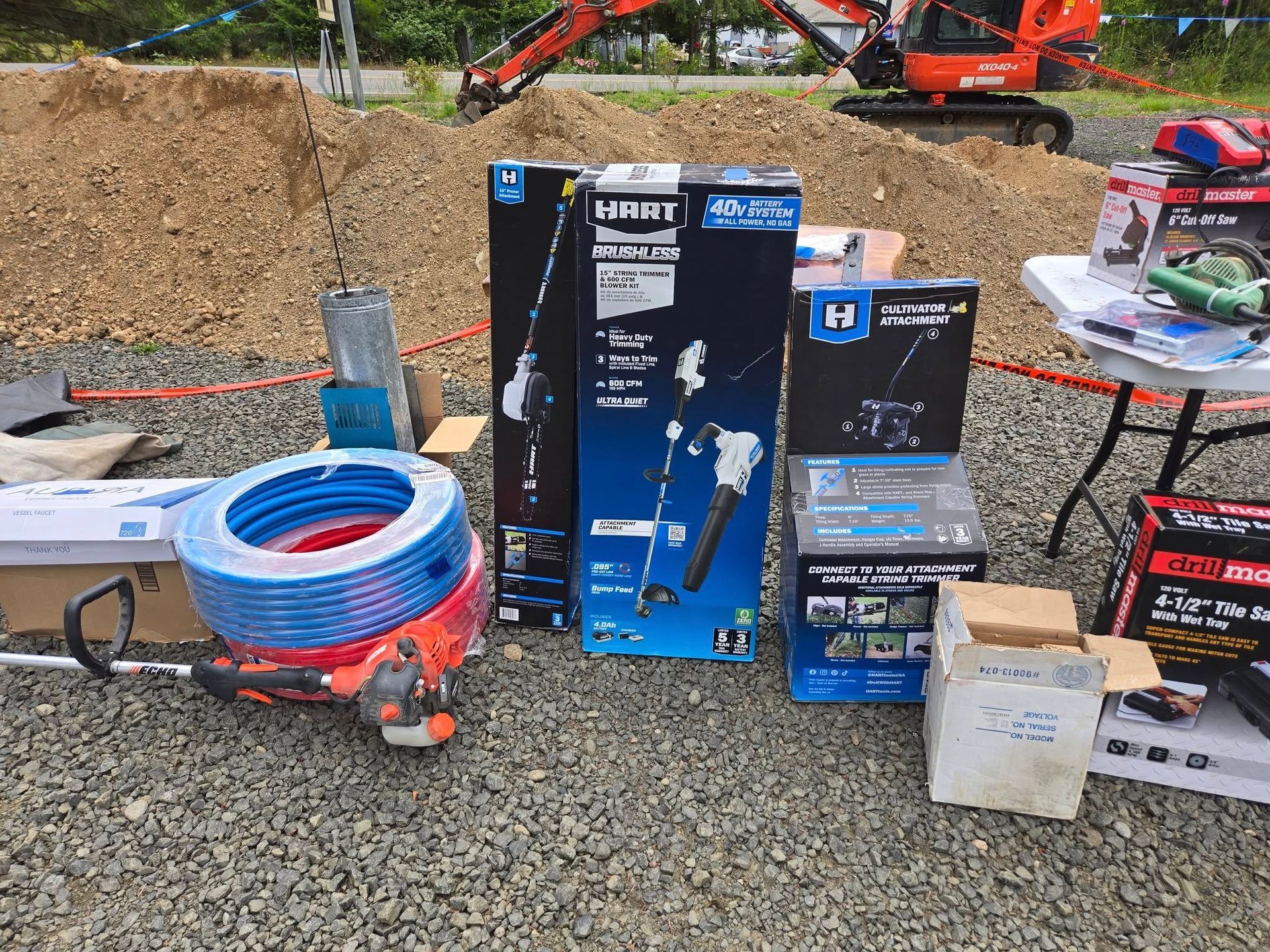 A bunch of tools and boxes are sitting on the ground.