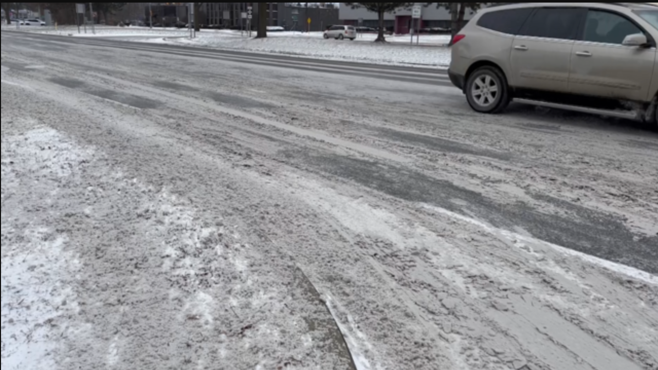 slushy roads with a silver car at a stop