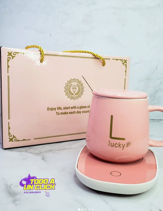Juego de taza rosa con calentador y caja de regalo; detalles dorados, texto 