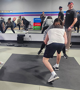 A group of people are doing exercises in a gym