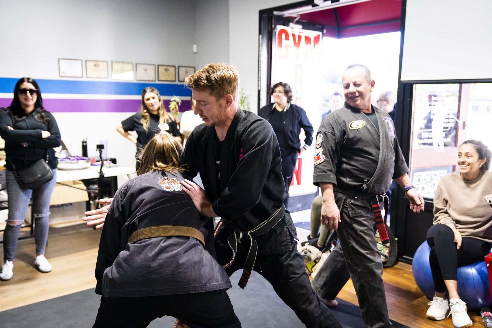 A group of people are practicing martial arts in a gym.