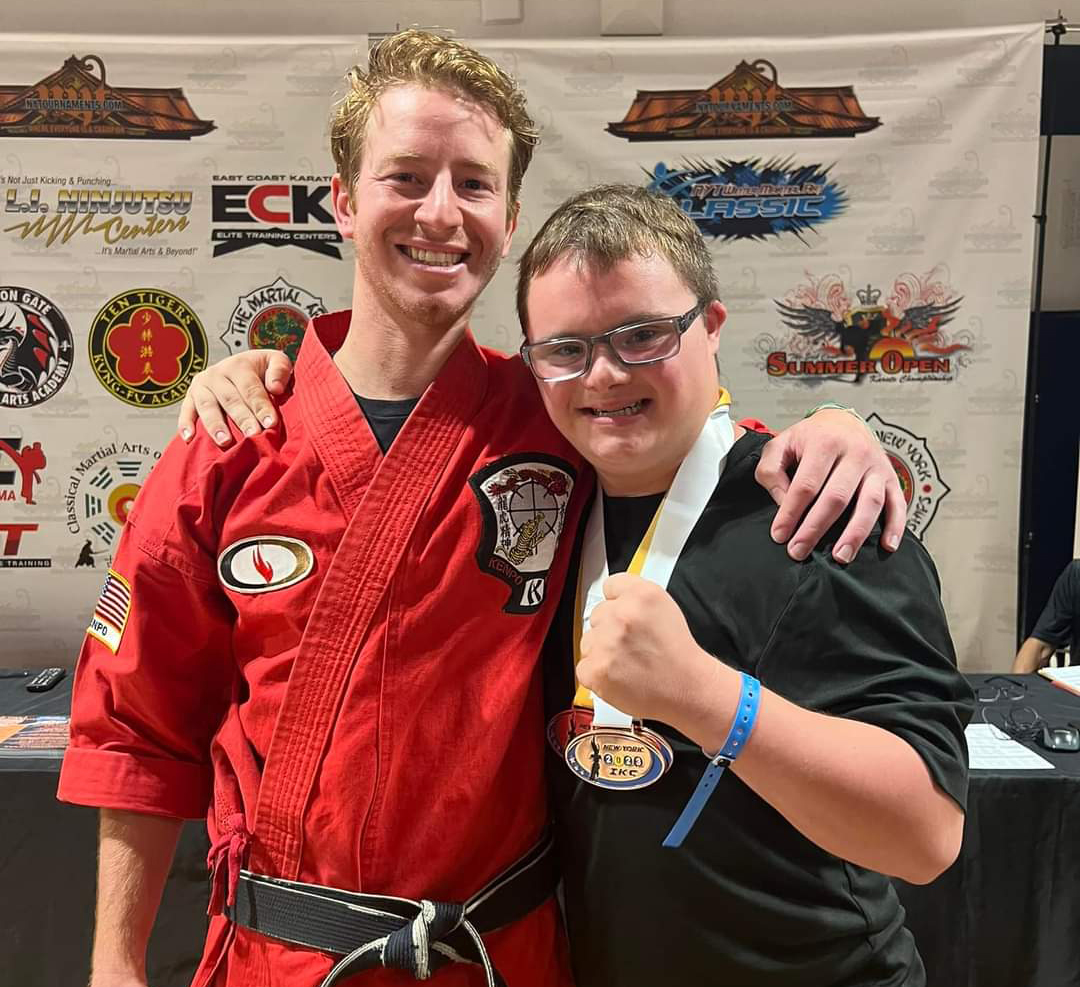Two men are posing for a picture in front of a banner that says eck