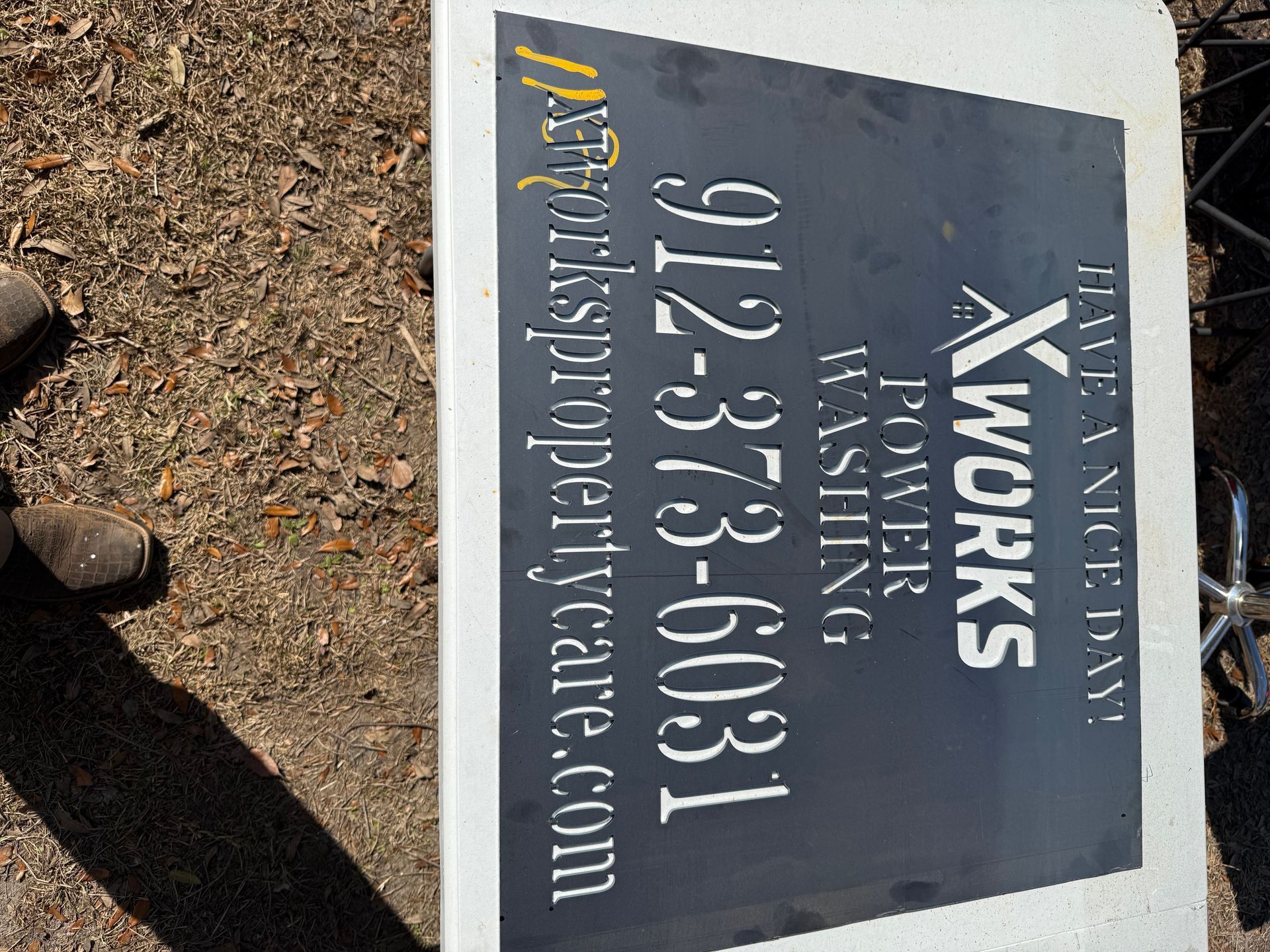 Sign for XWorks Power Washing: phone number, website, and 