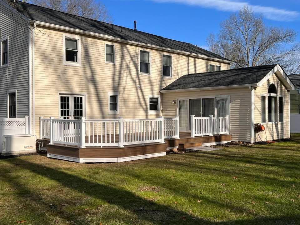 A large house with a large deck in front of it.