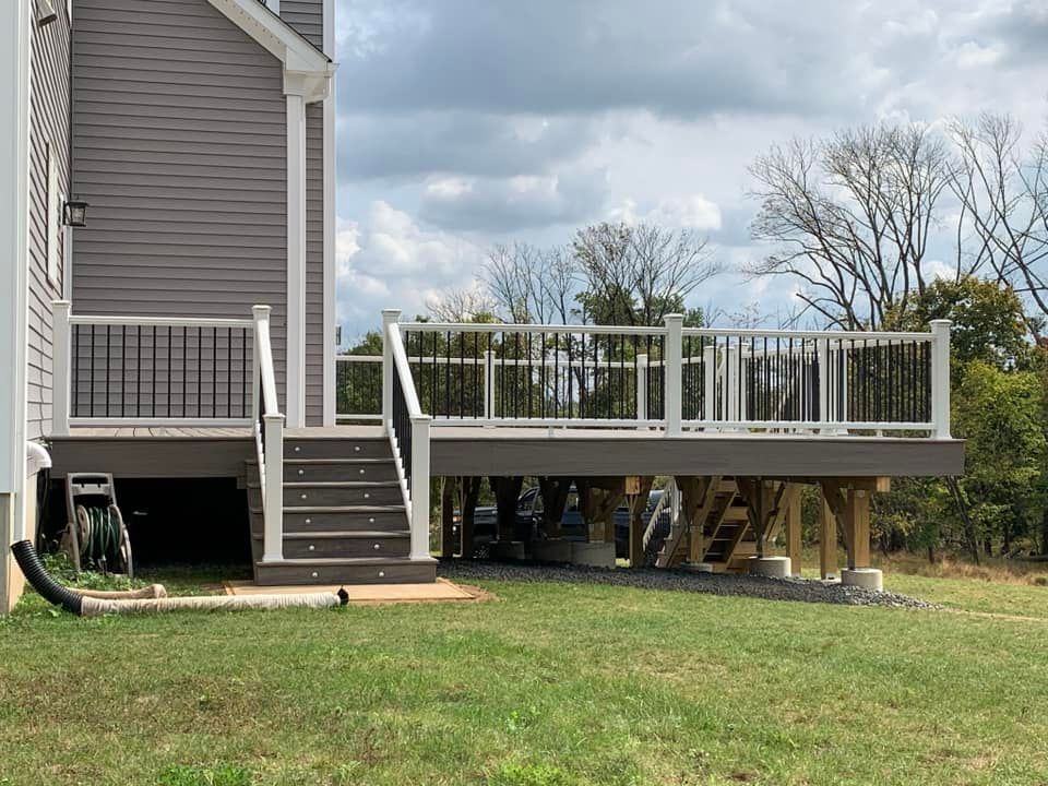 A large deck is being built in the backyard of a house.