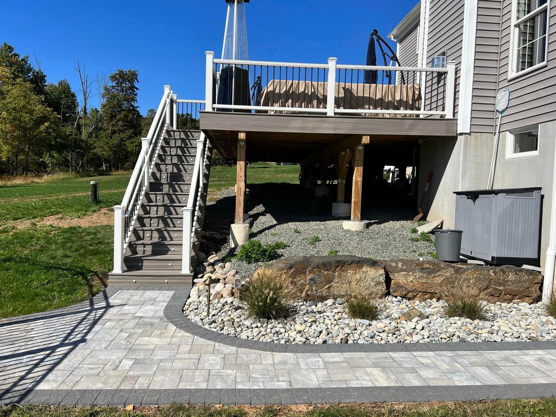 A house with a large deck and stairs leading up to it.