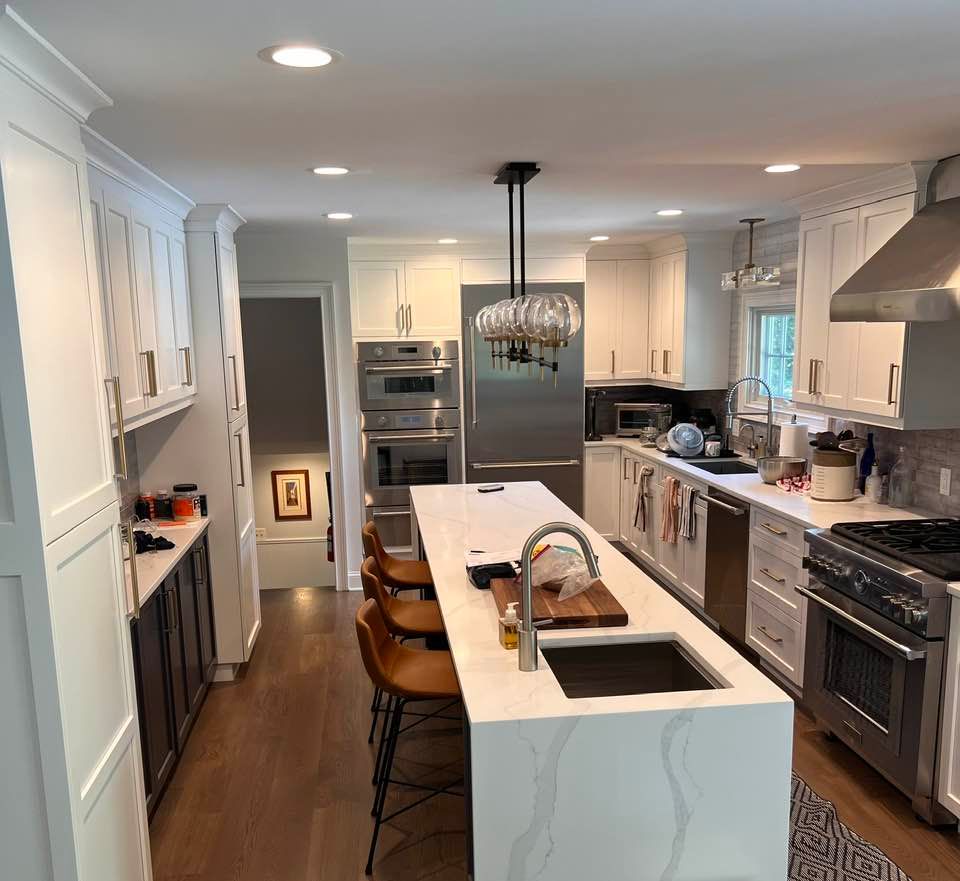 A kitchen with white cabinets and stainless steel appliances