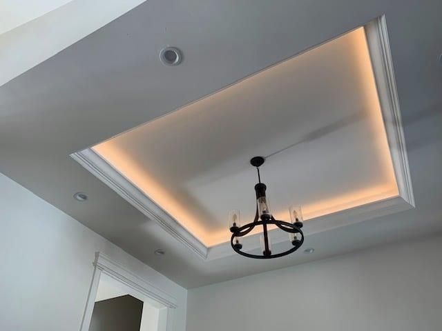 A chandelier is hanging from the ceiling of a room