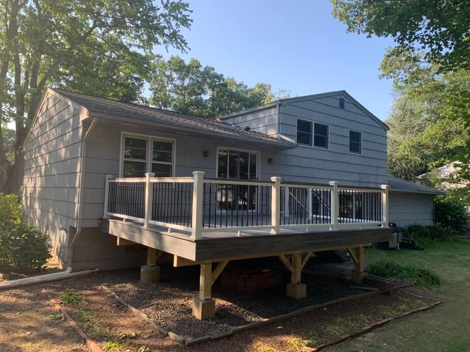 A house with a large deck in front of it.