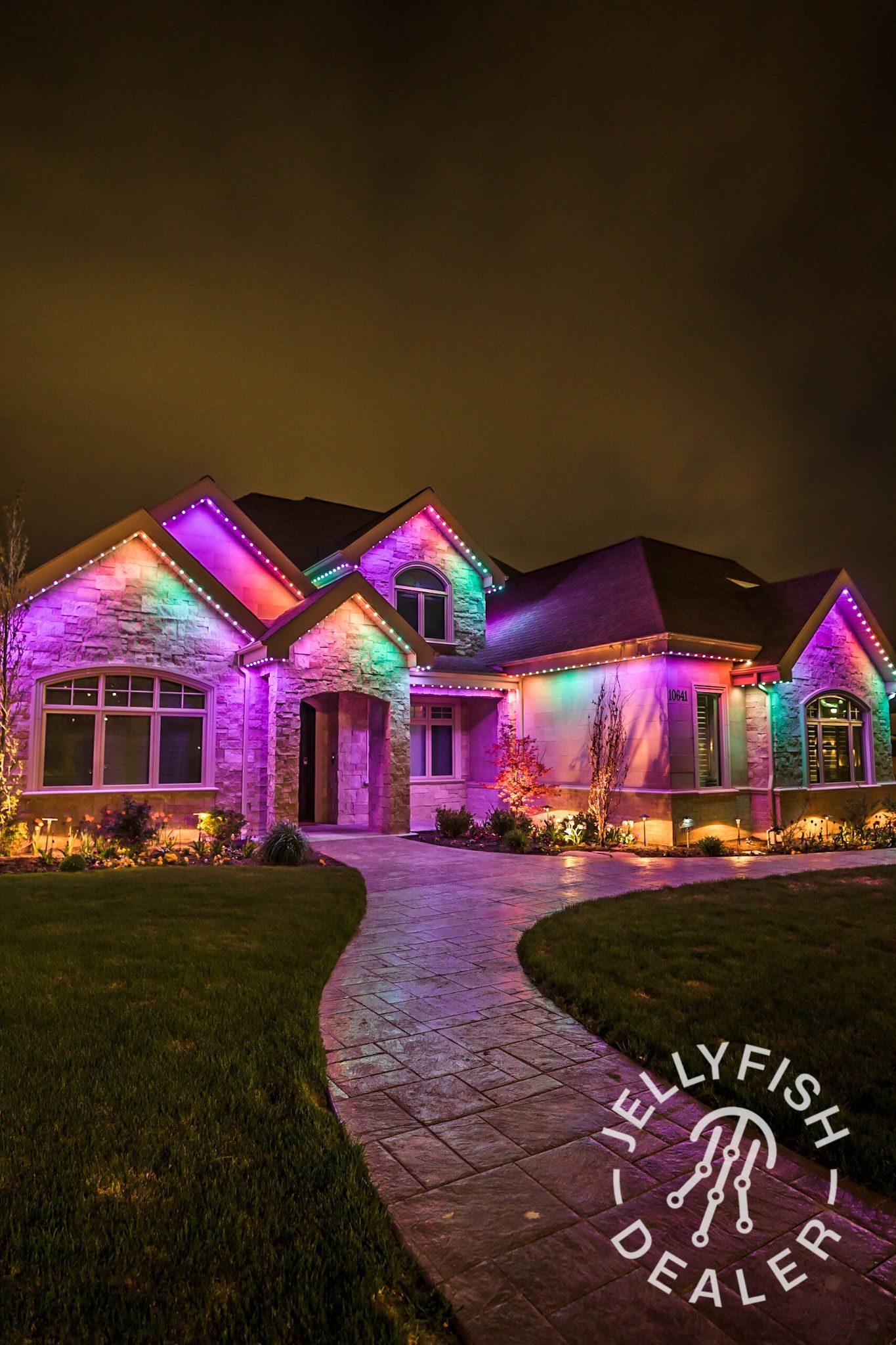 Large Bonney Lake house illuminated with JellyFish permanent LED holiday lights across the full roofline in purple and warm accent colors.