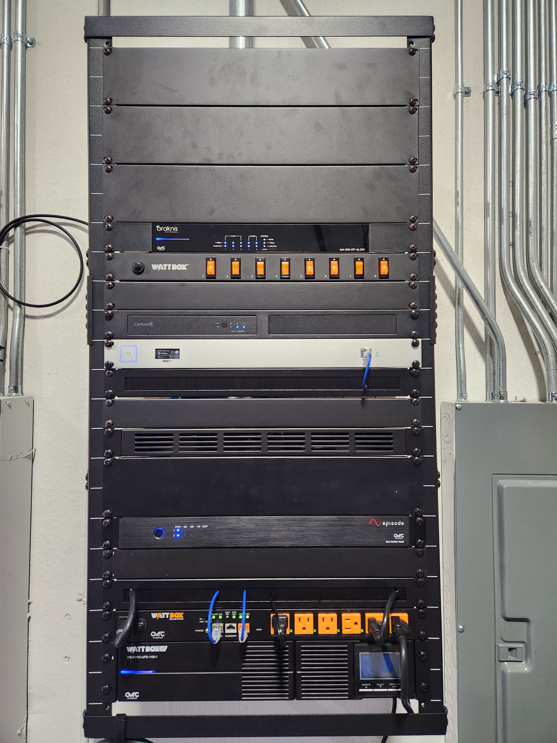 Finished commercial AV equipment rack with Control4 WattBox and Episode amplifier