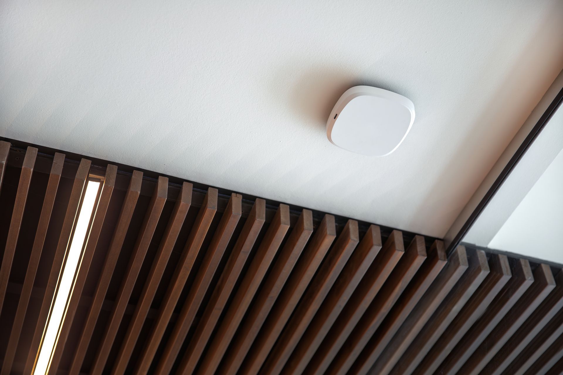 Ceiling-mounted wireless access point upgrade improving whole-home Wi-Fi coverage for smart home performance.
