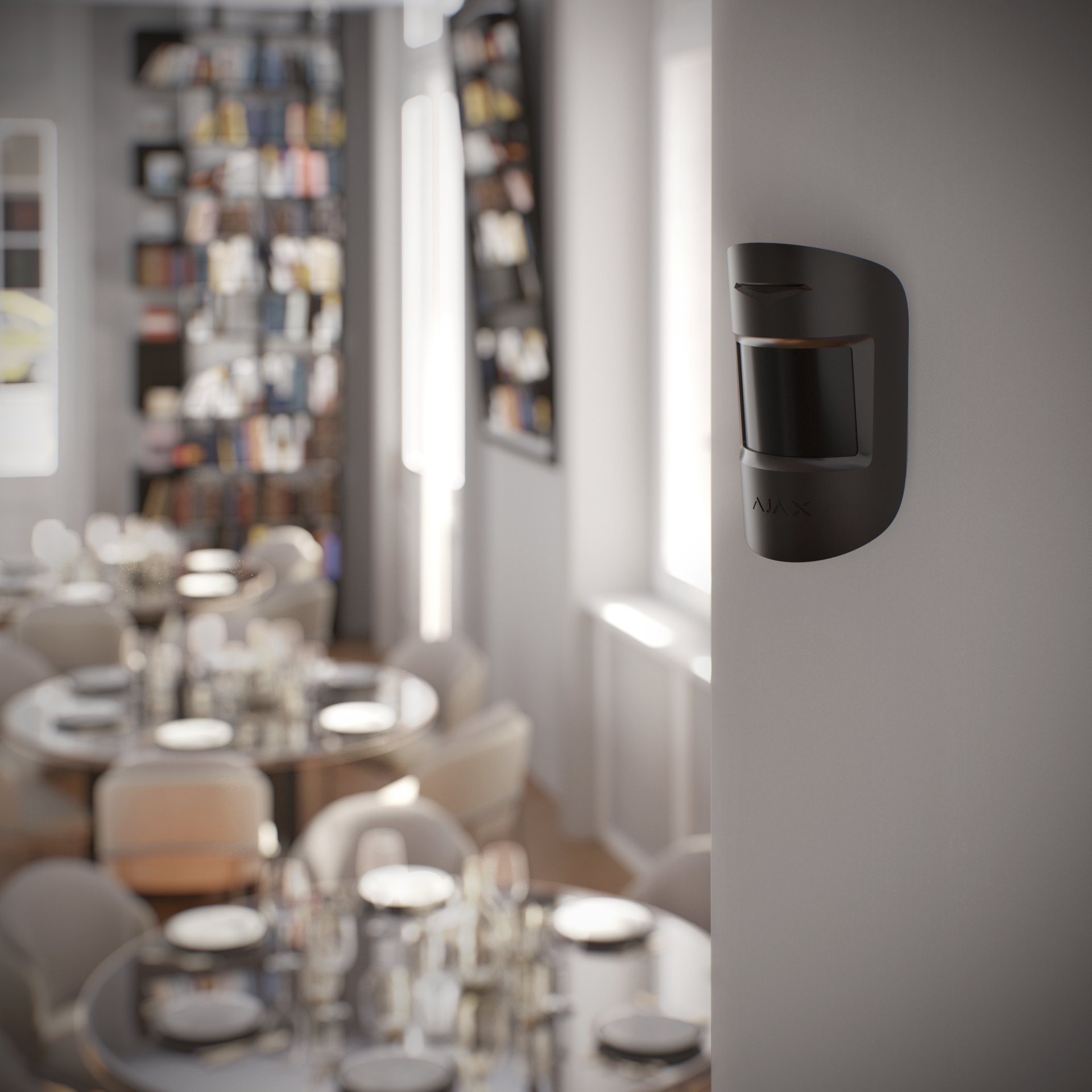 Ajax MotionProtect wireless motion detector in black, mounted on a restaurant wall