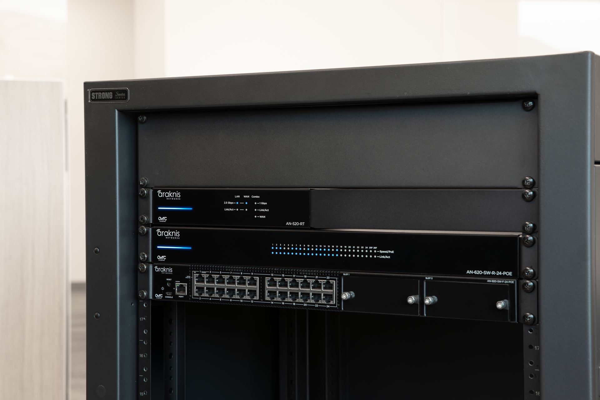 Araknis network rack with router, switch, and power management neatly installed.