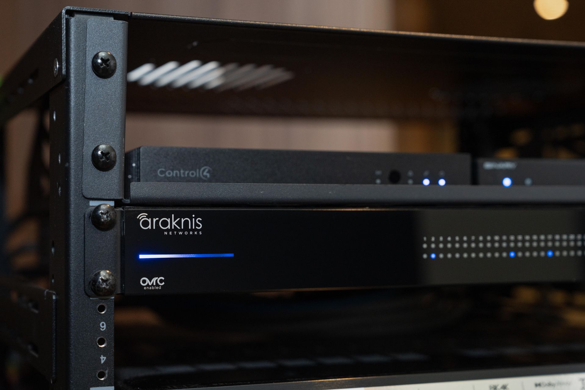 Close-up of a smart home network rack with an Araknis router and Control4 equipment for reliable home automation in Gig Harbor.