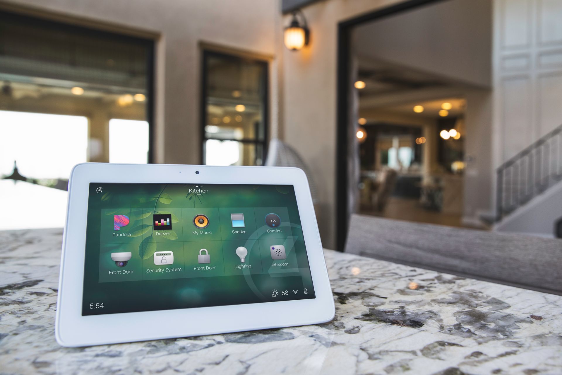 Wall-mounted touchscreen displaying smart home controls for lighting and motorized shades.