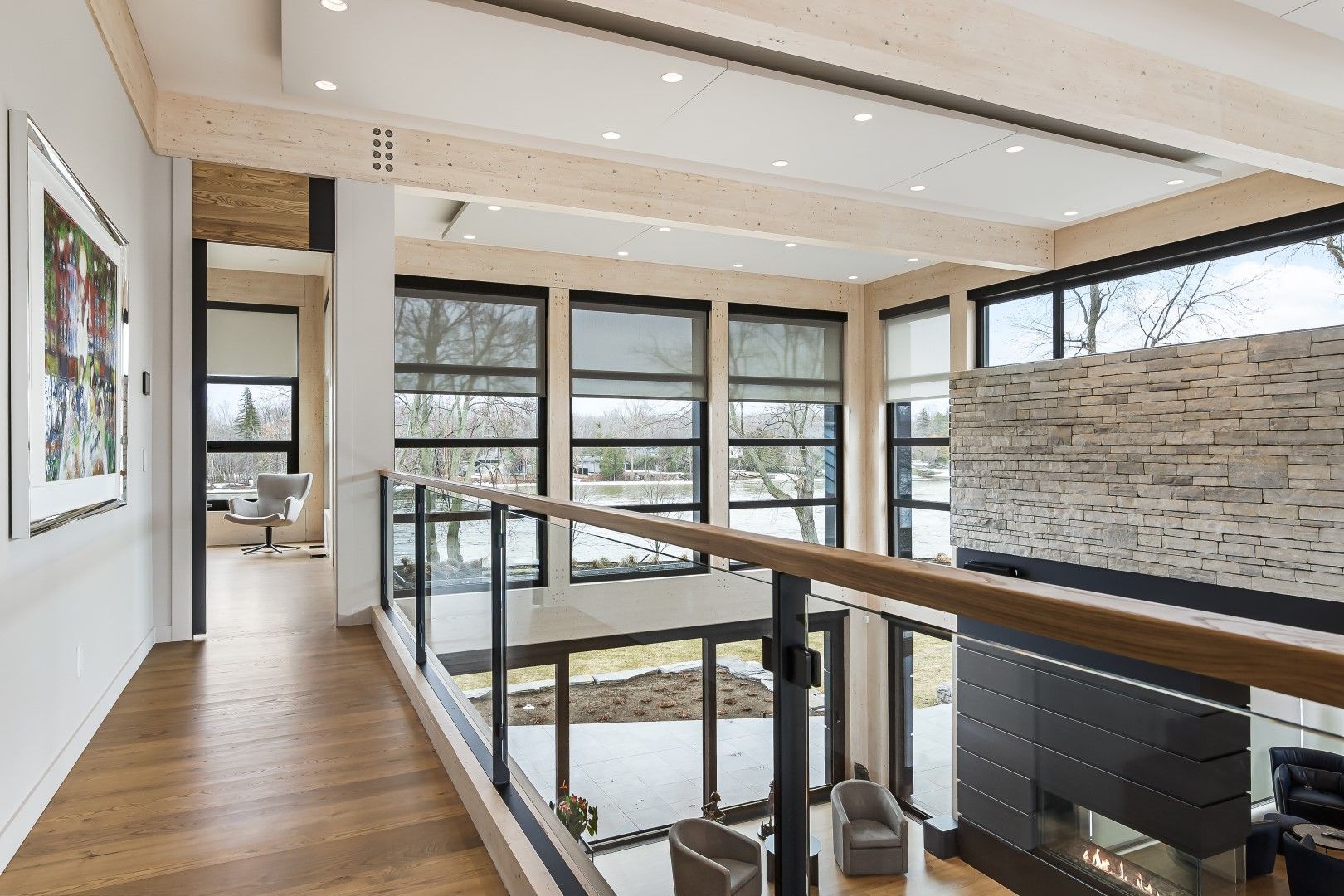 Open modern living space with large windows and motorized shades.