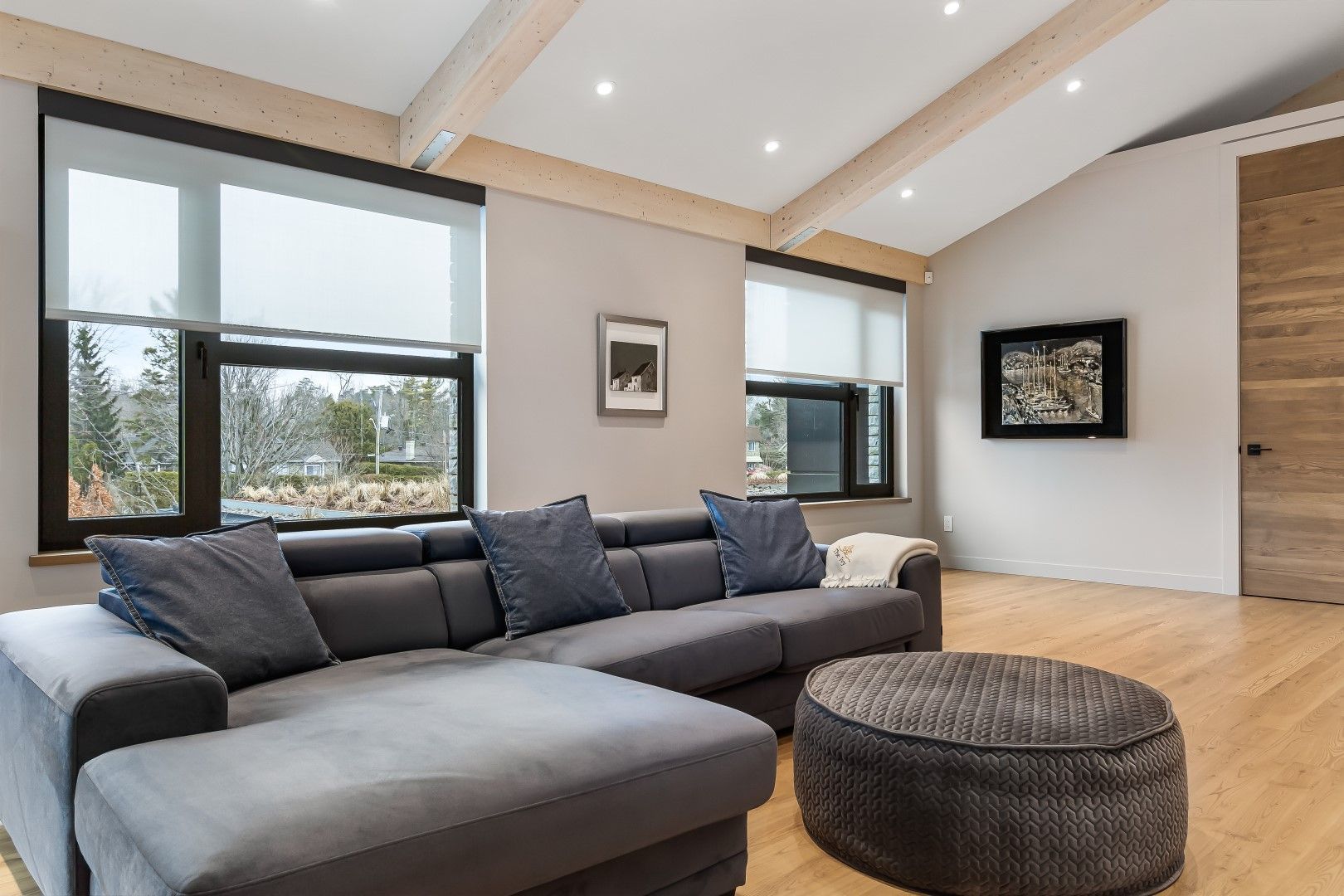Clara Shades motorized roller blinds installed in modern Kent home with full-width windows and ambient lighting