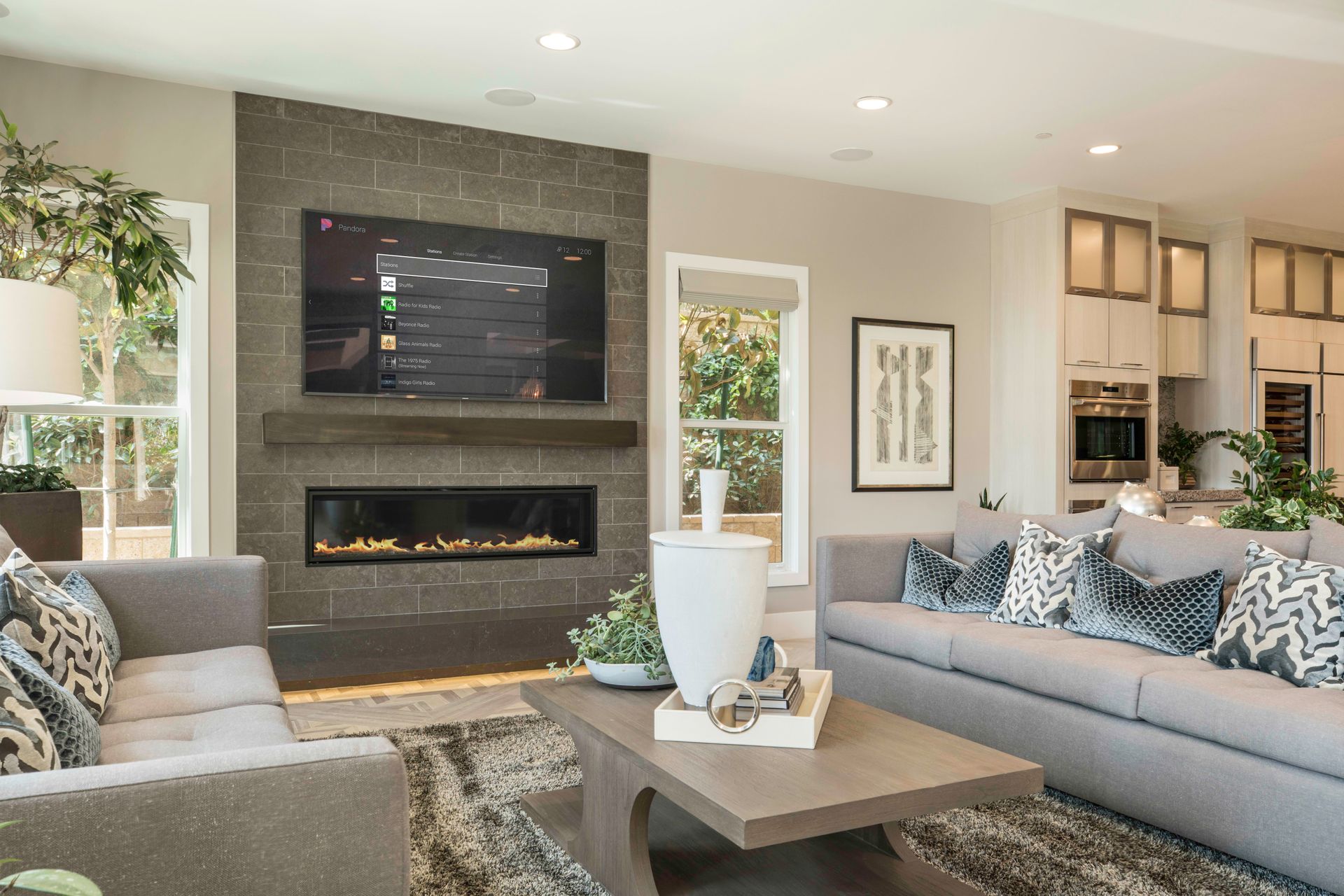 Modern Tacoma living room with a wall-mounted TV, integrated fireplace, and smart home entertainment system.