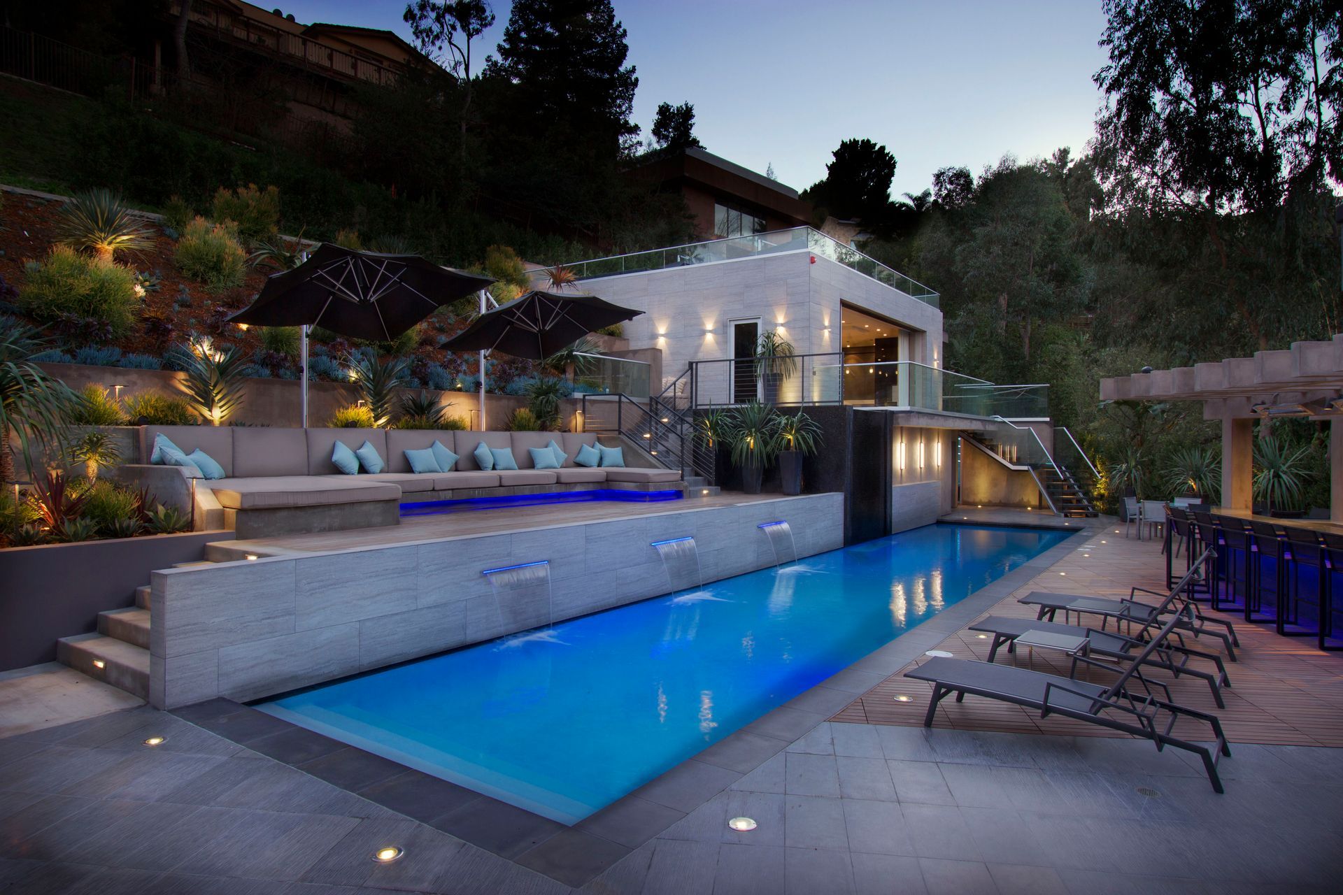 Outdoor entertainment AV installation — covered patio with mounted TV and landscape audio