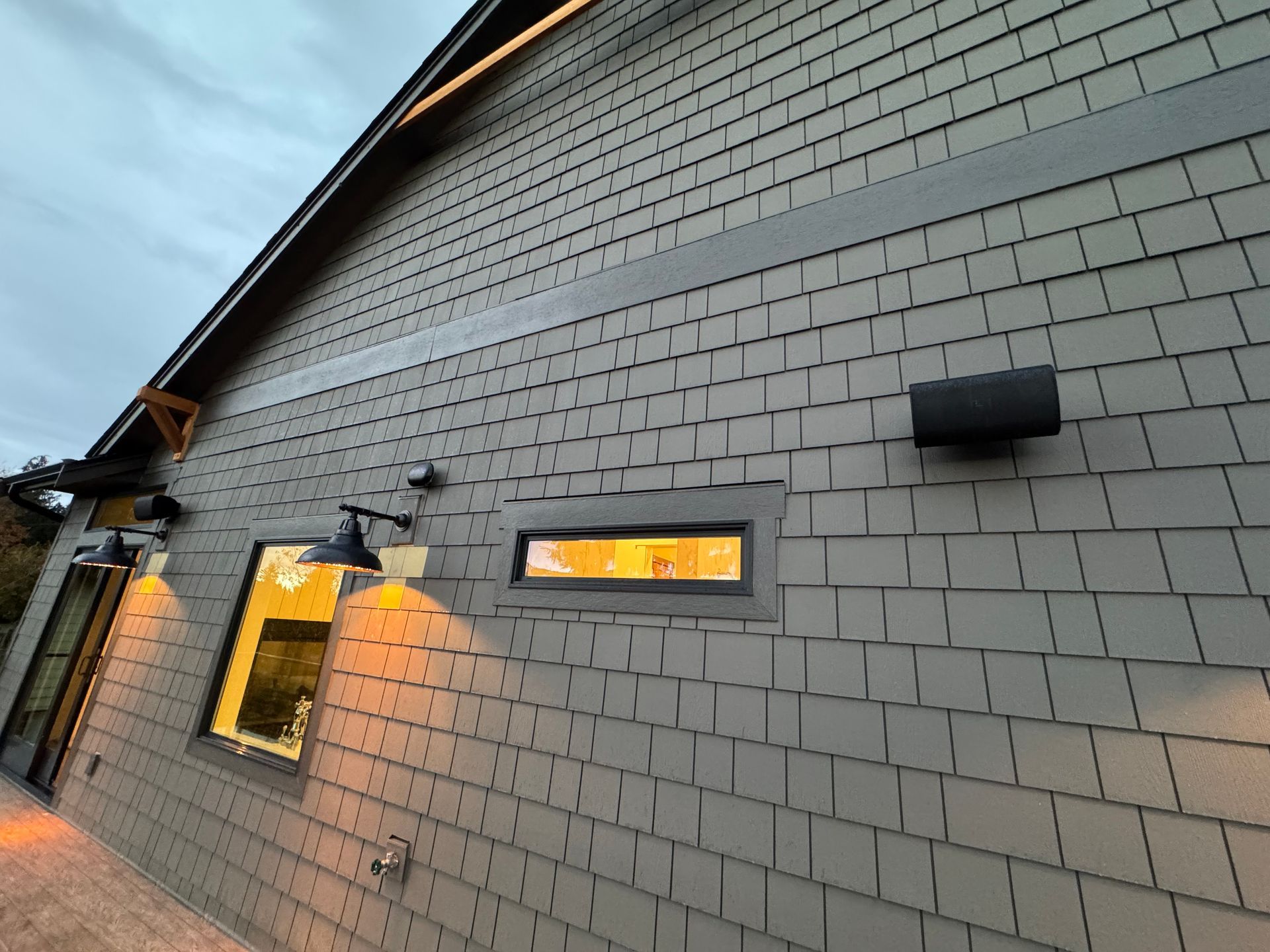 Completed Bonney Lake smart home exterior showing integrated black outdoor APs and matching speakers