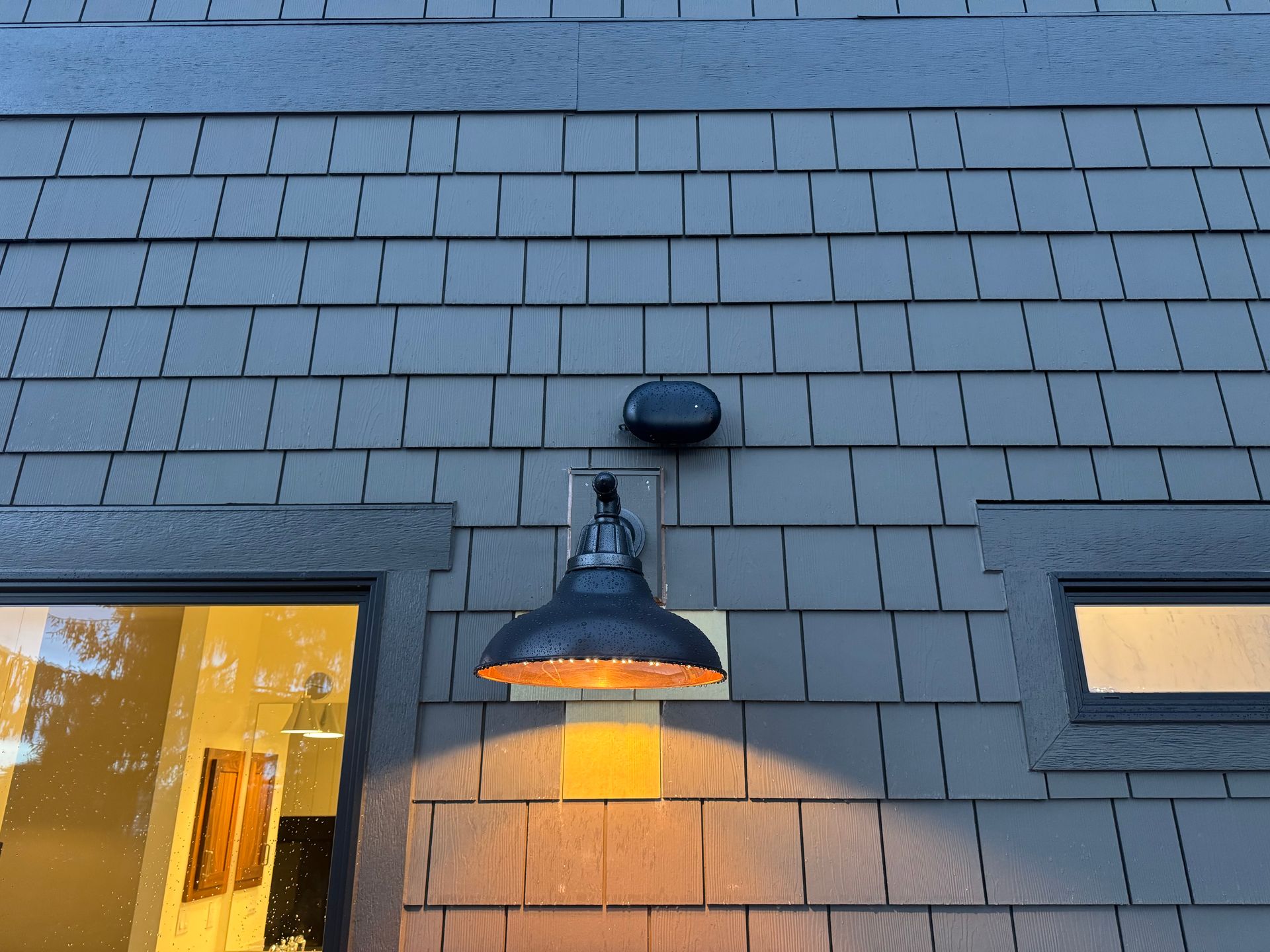 Finished matte black AP6-PRO Outdoor access point mounted above outdoor light fixture.