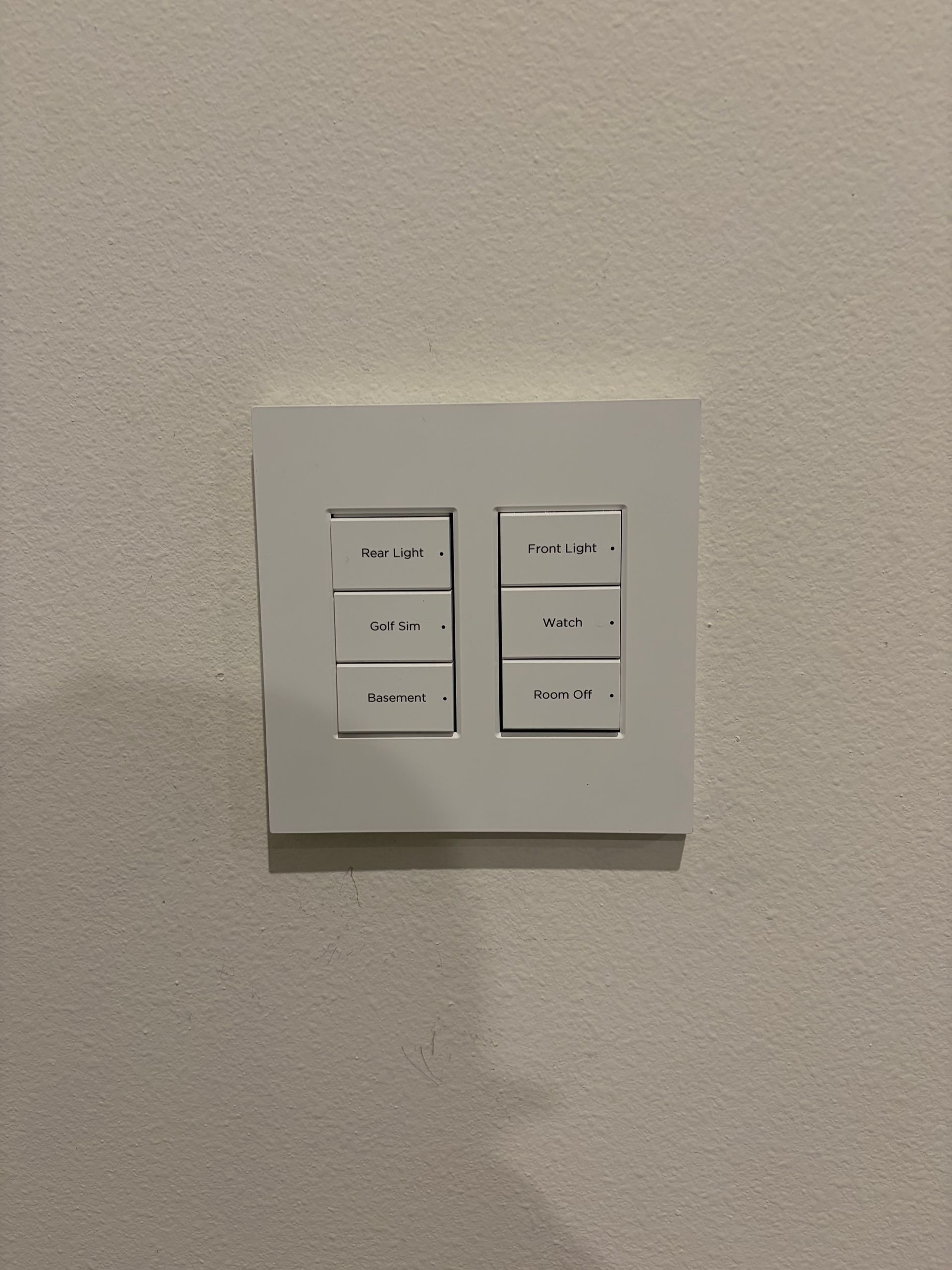 Control4 keypad with Golf Sim Watch Front Light and Room Off scenes installed in simulator room