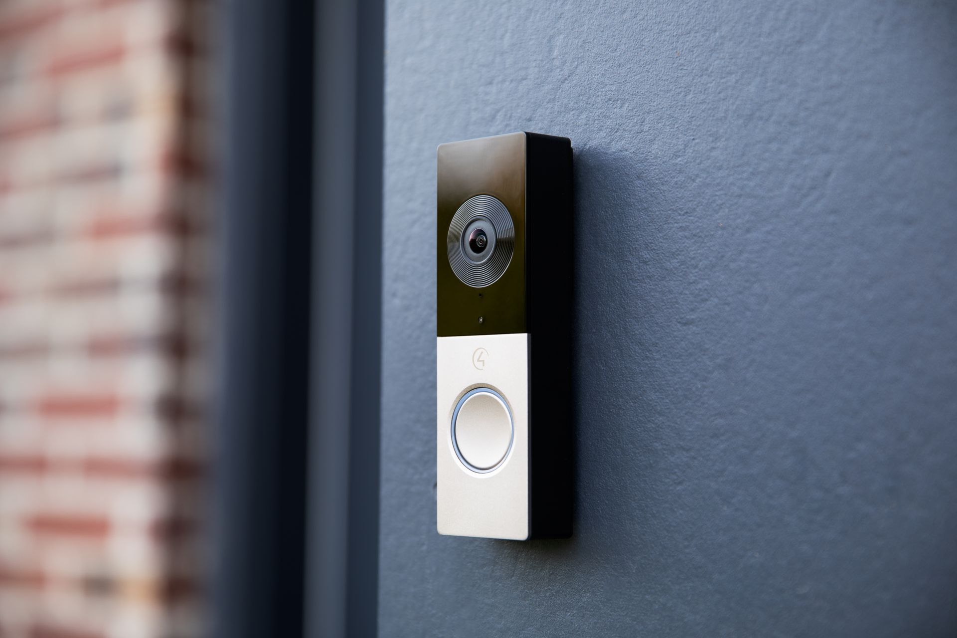 Video doorbell camera mounted on an exterior wall for home security.