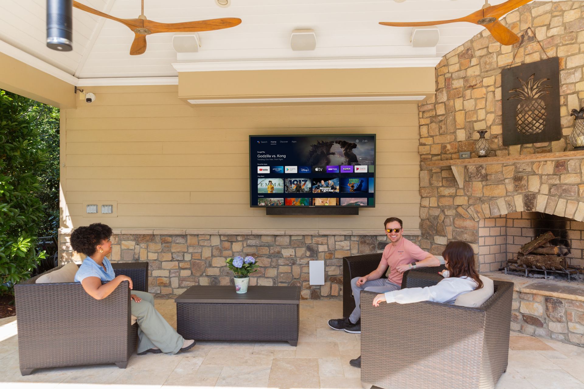 Outdoor entertainment area with TV, speakers, and patio seating supported by strong outdoor Wi-Fi