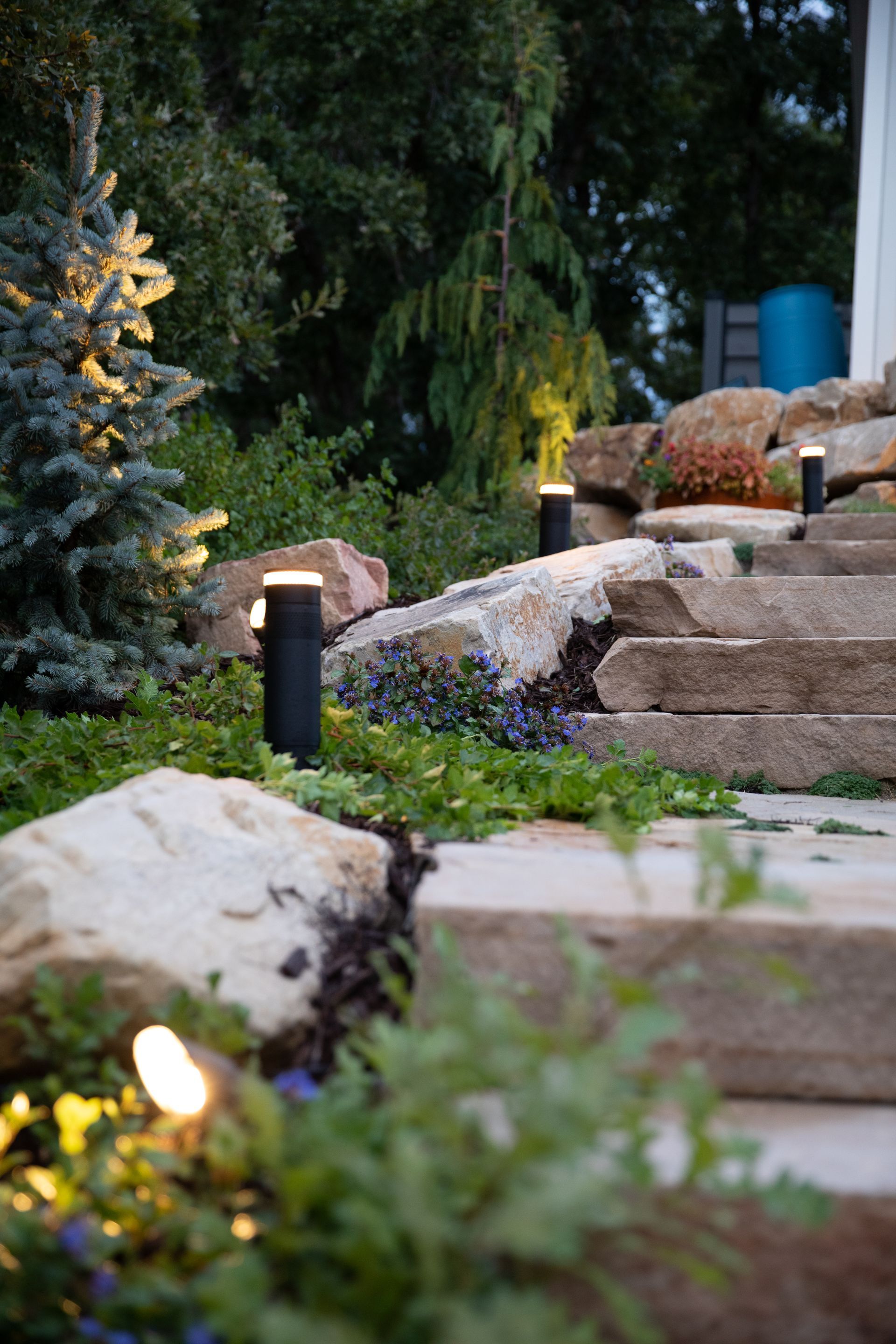 Pathway lighting along stone garden steps at twilight