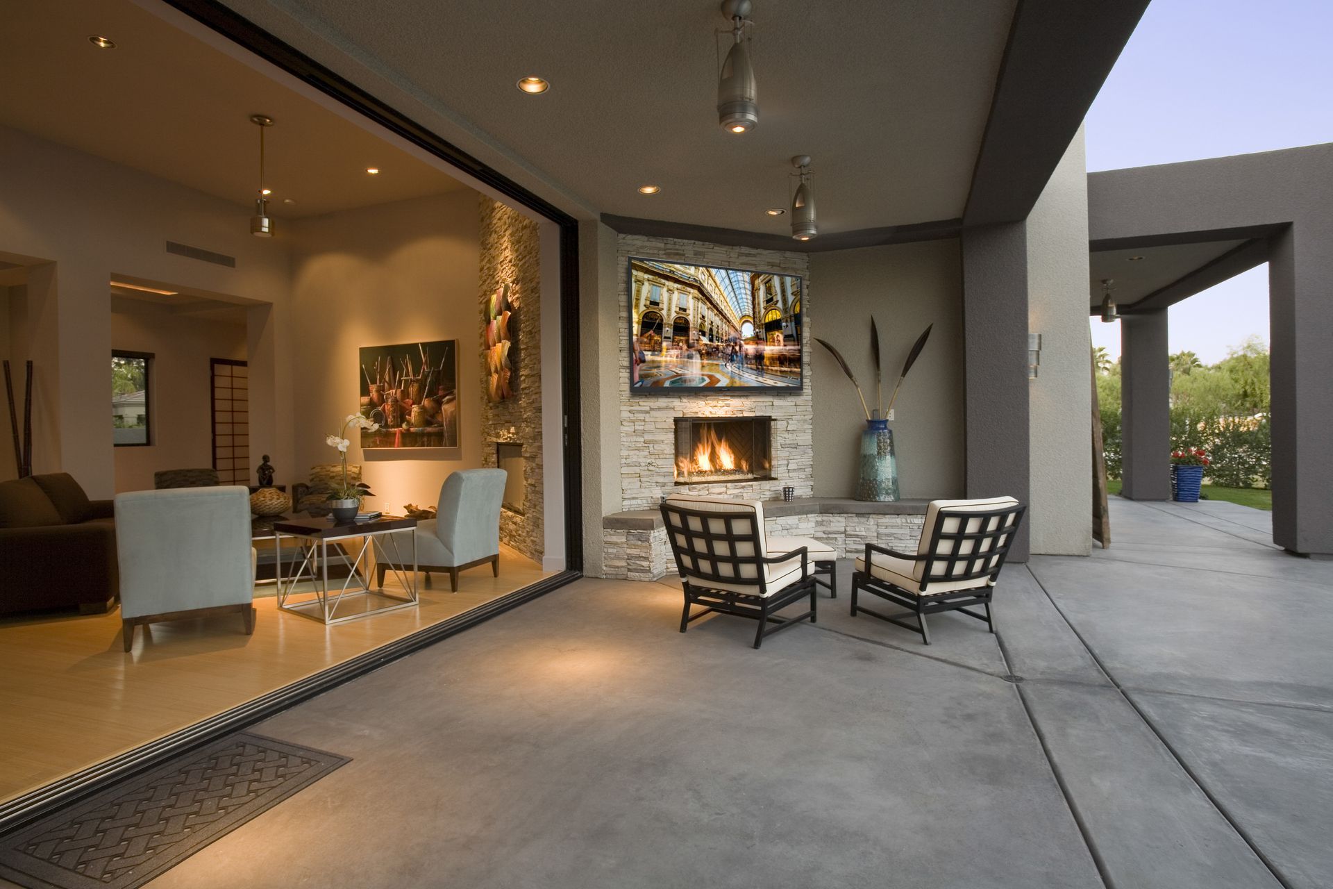 Luxury backyard with smart lighting and entertainment system at sunset