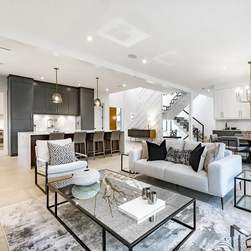 Modern open-concept living space with kitchen island, seating, and living room furniture.