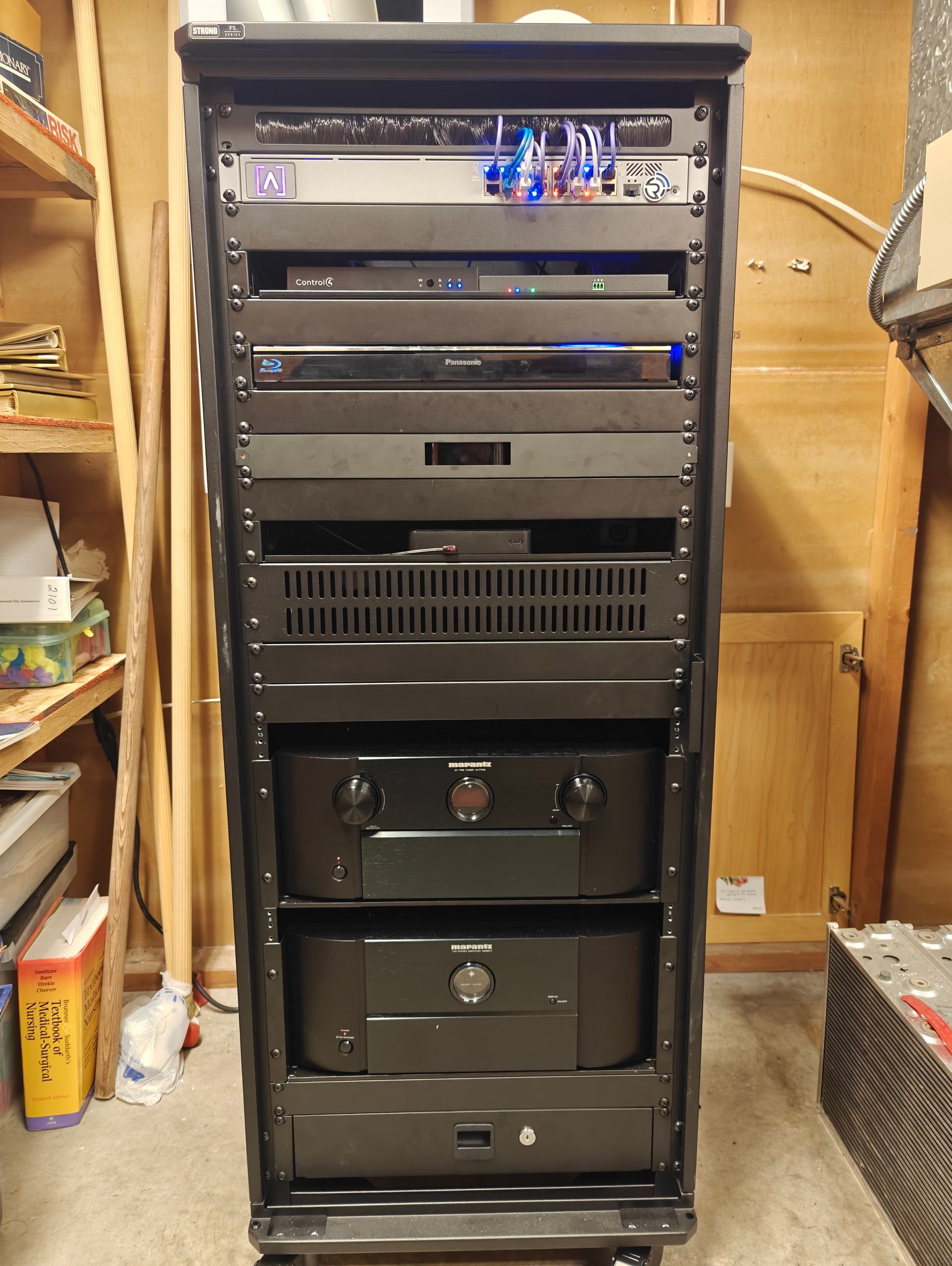 Clean home theater equipment rack built by Rivas Technology Group