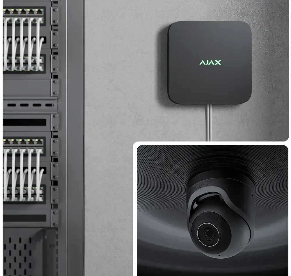 A black ajax device is mounted on a wall