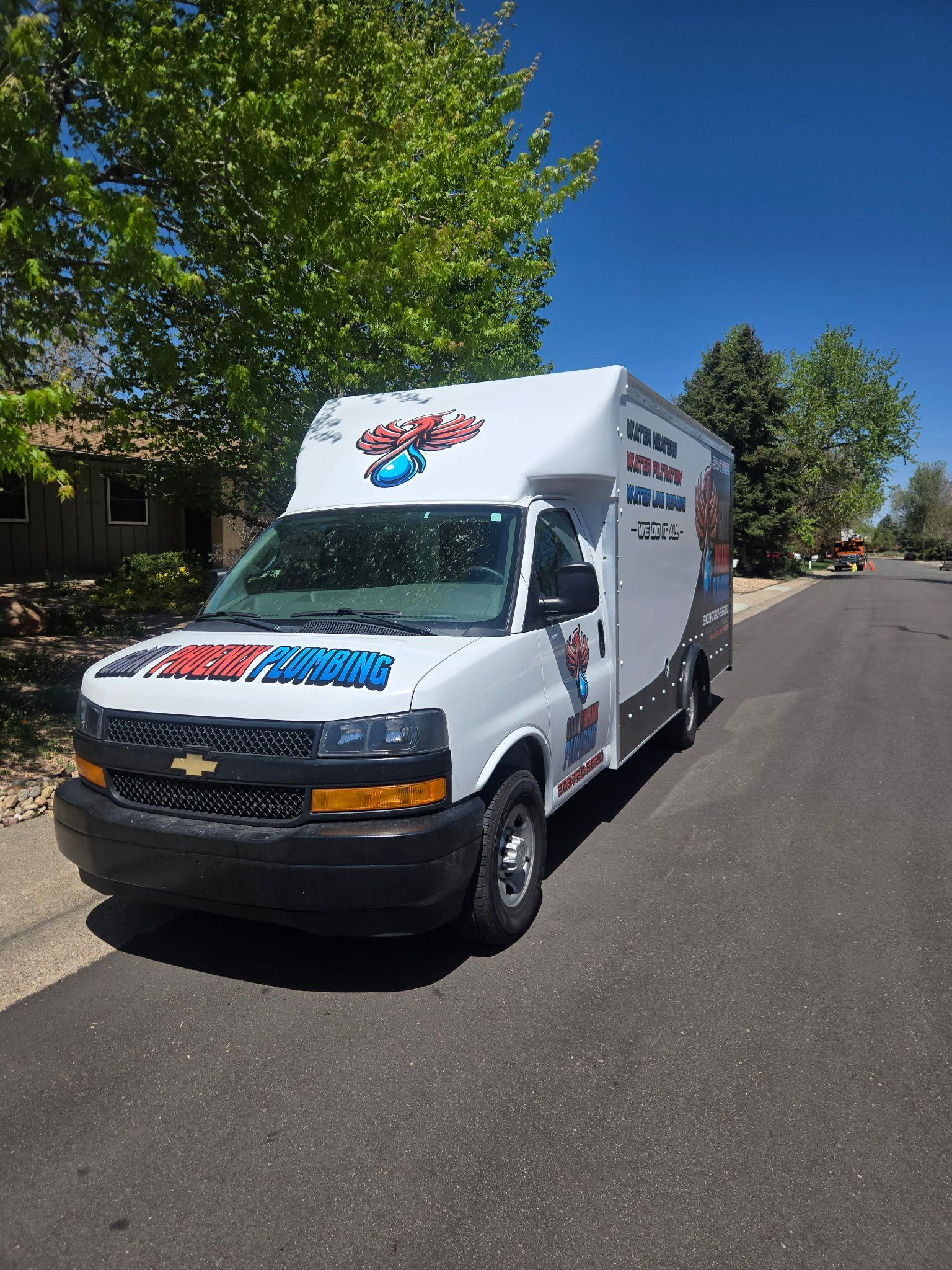 A white van is parked on the side of the road.
