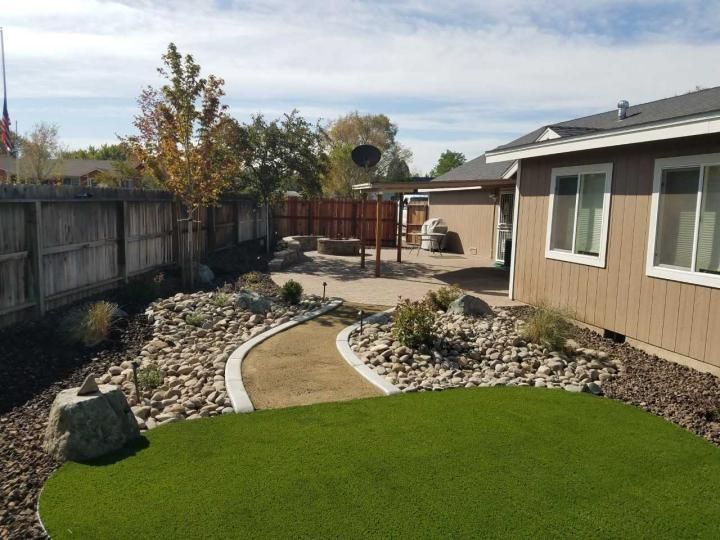 A house with a large lawn in front of it.