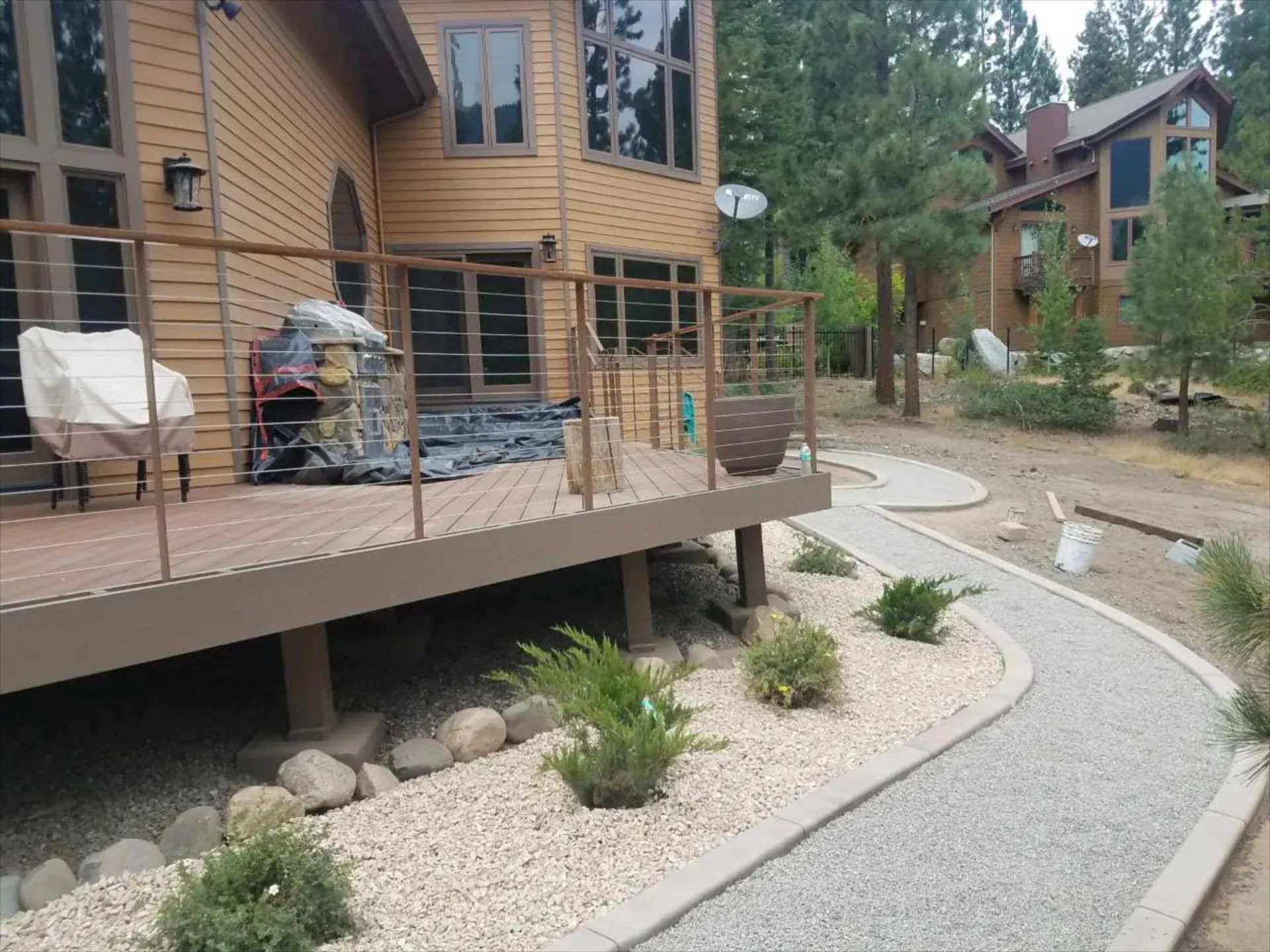 A house with a deck and a walkway in front of it