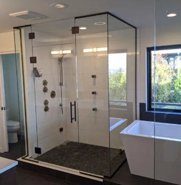 A bathroom with a bathtub and a shower stall