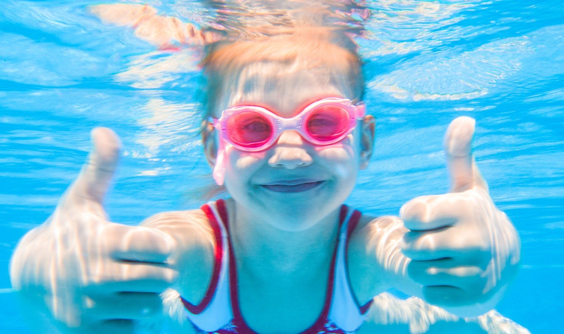 Girl swimming in goggles