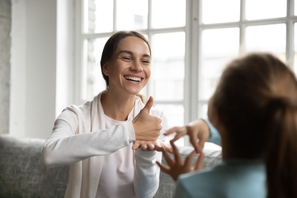 Occupational Therapist Doing Finger Exercises With A Kid — Occupational Therapist in Yeppoon, QLD