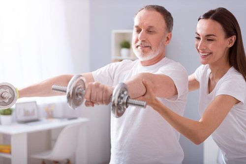 Exercising With A Middle Aged Patient — Occupational Therapist in Yeppoon, QLD
