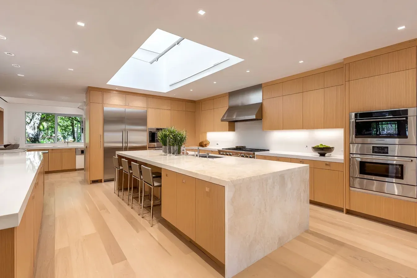 Kitchen renovation Richmond BC | Kitchen remodeling Richmond Canada | Scandinavian quartz island, rift-cut oak cabinetry, and glass-paneled lighting. Richmond builders craft serene, natural interiors. Each project reflects beauty in restraint.