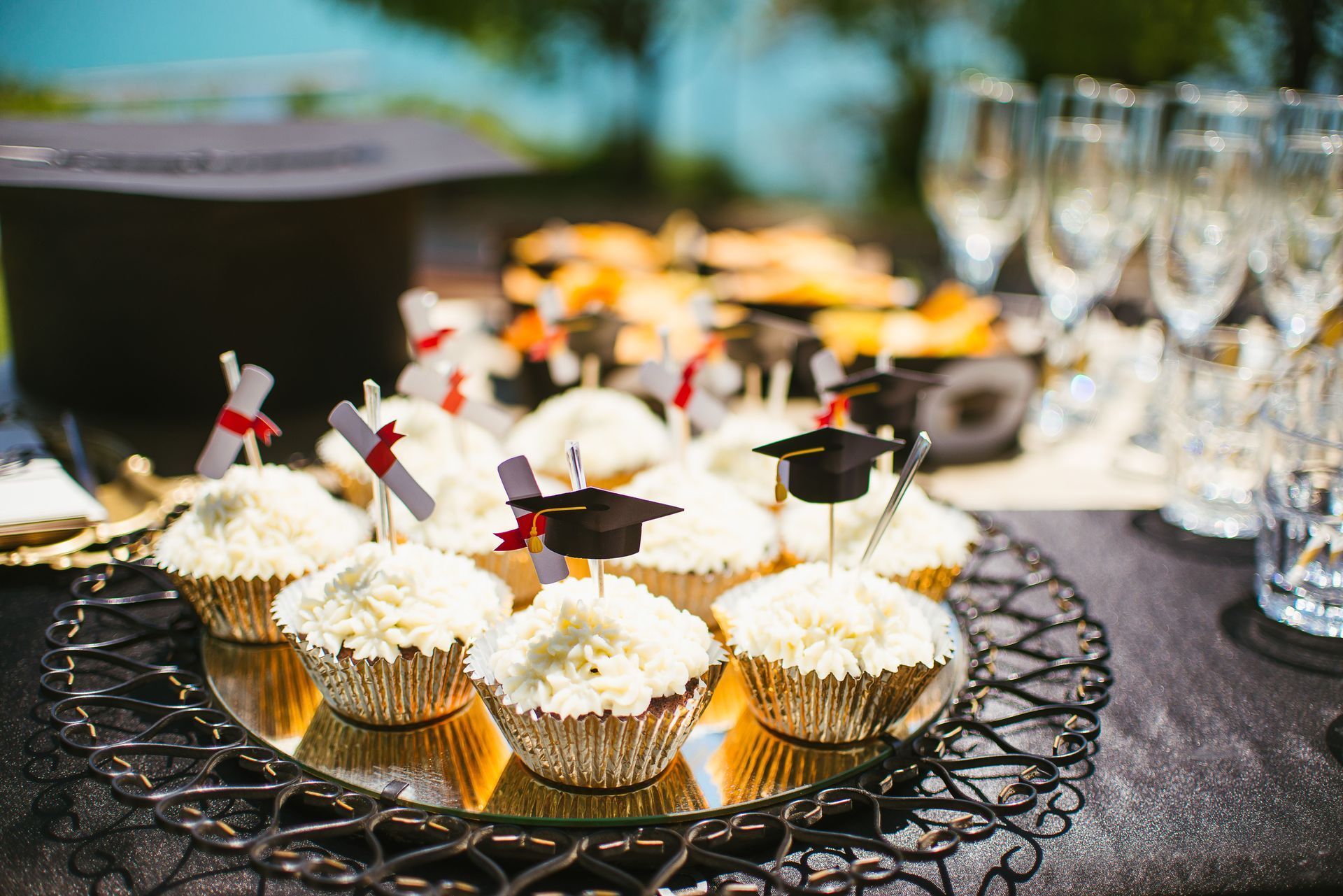 A table topped with cupcakes decorated with graduation caps and diplomas.