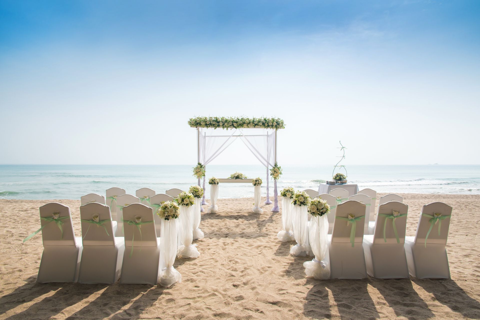 A wedding ceremony is taking place on the beach.